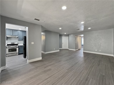 Unfurnished living room with a textured ceiling, w