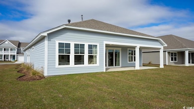 Back of house featuring a patio and a lawn