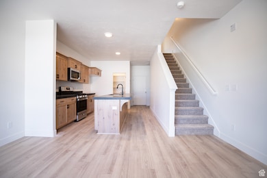 View of kitchen and stairs from adjoining family room.