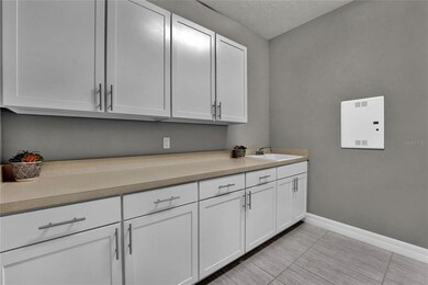 Large Laundry Room with cabinets throughout