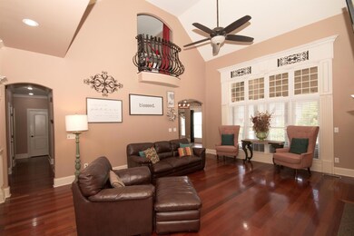 Huge family room with Juliette balcony and soaring ceilings.