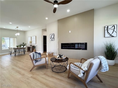 Living area with light wood-style floors, recessed