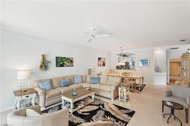 Living room with ornamental molding, ceiling fan, 
