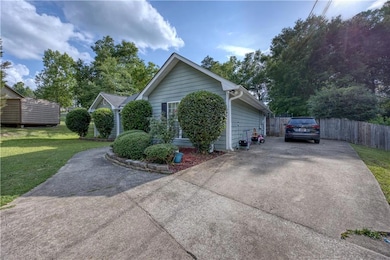 View of side of home with concrete driveway
