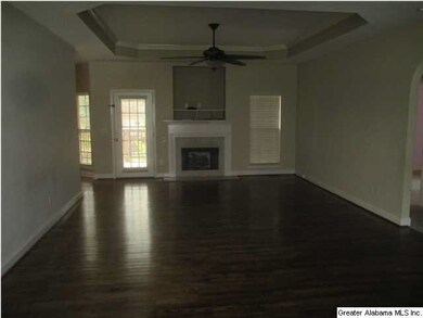 View of the living room shows fireplace, hardwood 