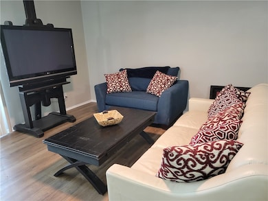 Living room with wood finished floors and baseboar