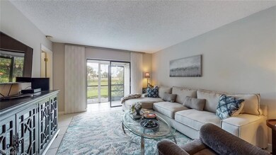 Modern furniture, wall hung TV, white tile floors 