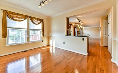 Gleaming hardwood flooring graces the dining room,