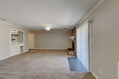 Unfurnished living room with brick wall, a brick f