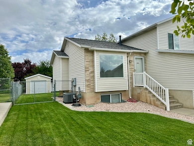 Rear view of property featuring a gate and a shingled roof