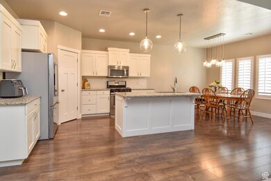 Kitchen featuring visible vents, dark wood-style floors, recessed lighting, white cabinets, and appliances with stainless steel finishes