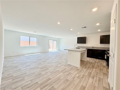 Kitchen featuring a center island, light wood-styl
