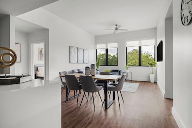 Dining room featuring a ceiling fan, wood finishe