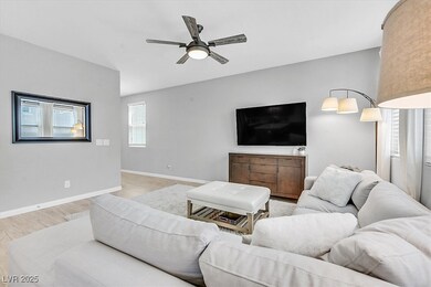 Living room with wood finished floors and a ceiling fan