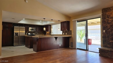 Kitchen with visible vents, a sink, a tray ceiling