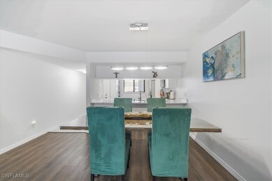 Dining room featuring dark wood-style flooring
