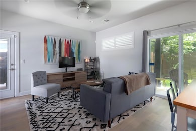 Living area featuring wood finished floors, a cei