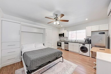 Bedroom featuring washer / dryer, light wood-type