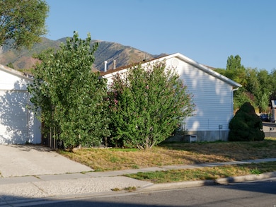 View of home's exterior with a mountain view and a garage