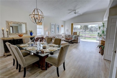 Dining space with ceiling fan with notable chandel
