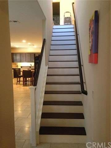 Dark wood staircase with white risers