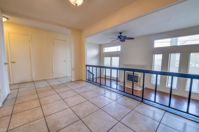 Spare room featuring baseboards, a ceiling fan, an