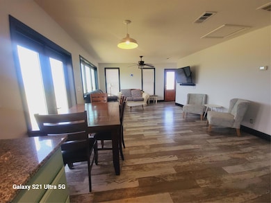 Dining room with wood finished floors, ceiling fa
