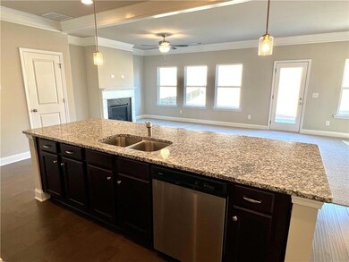 Kitchen featuring stainless steel dishwasher, orna