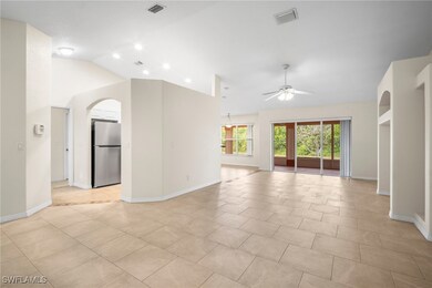 Unfurnished living room featuring lofted ceiling,