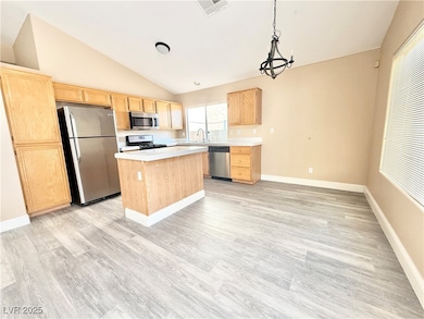 Kitchen with stainless steel appliances, light bro