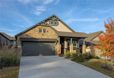 View of front of house with stone siding, concret