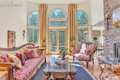 Living area with wood finished floors and a high c