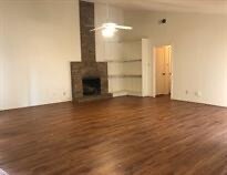 Unfurnished living room featuring dark wood-style