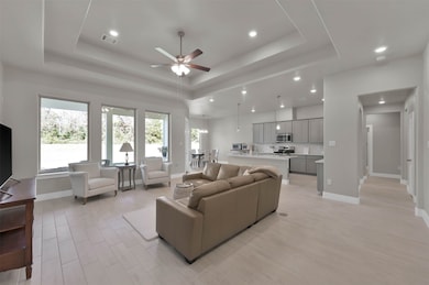 Very open floorplan with tray ceilings & tile wood