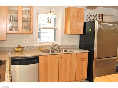 Granite counters and a glass front cabinet add gla