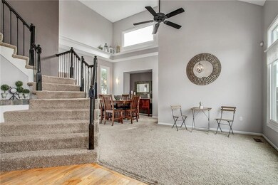 To your right is the living room with a vaulted ca