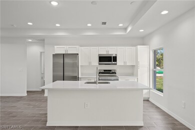 Kitchen with an island with sink, stainless steel
