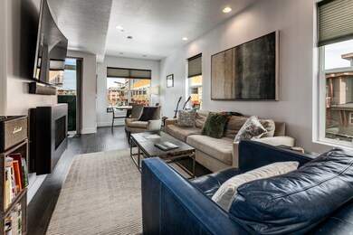 Living room with a fireplace, recessed lighting, dark wood-style flooring, and a textured ceiling