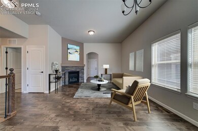 Virtually Staged Living room with a stone fireplac