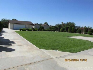 Backyard with lush lawn.  Drive way from frontyard