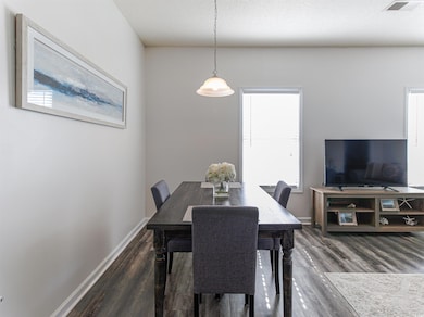 Dining space with dark wood-type flooring