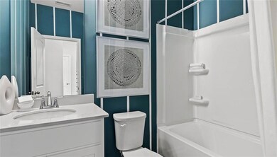 Full bathroom featuring vanity, toilet, and shower