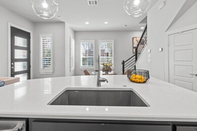 Kitchen with light stone counters, stainless steel