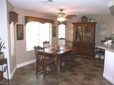Dining area with ceiling fan and tile floor