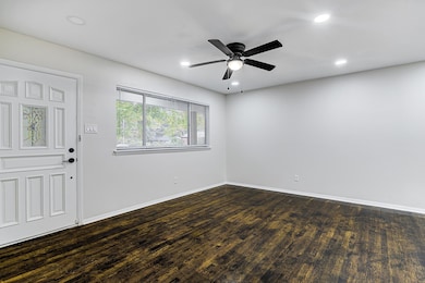 Foyer featuring ceiling fan and dark hardwood / wo