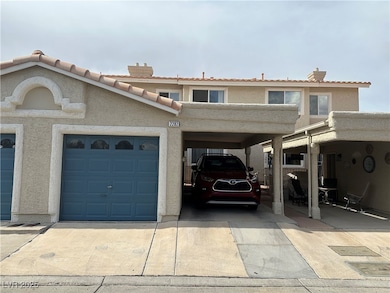 View of property with a tiled roof, driveway, stuc