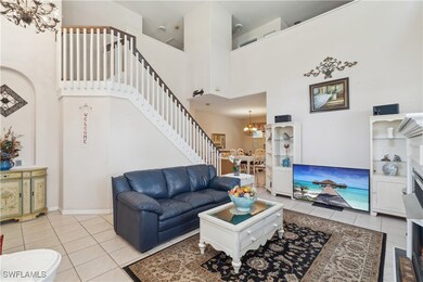 Tiled living room with a towering ceiling and a no