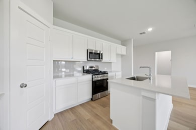 Kitchen in the Hadley home plan by Trophy Signature Homes – REPRESENTATIVE PHOTO