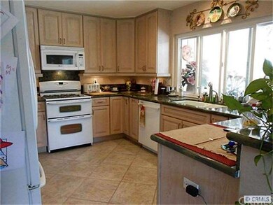 Kitchen features newer appliances, cabinets, grani