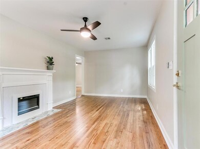 Unfurnished living room with ceiling fan and light